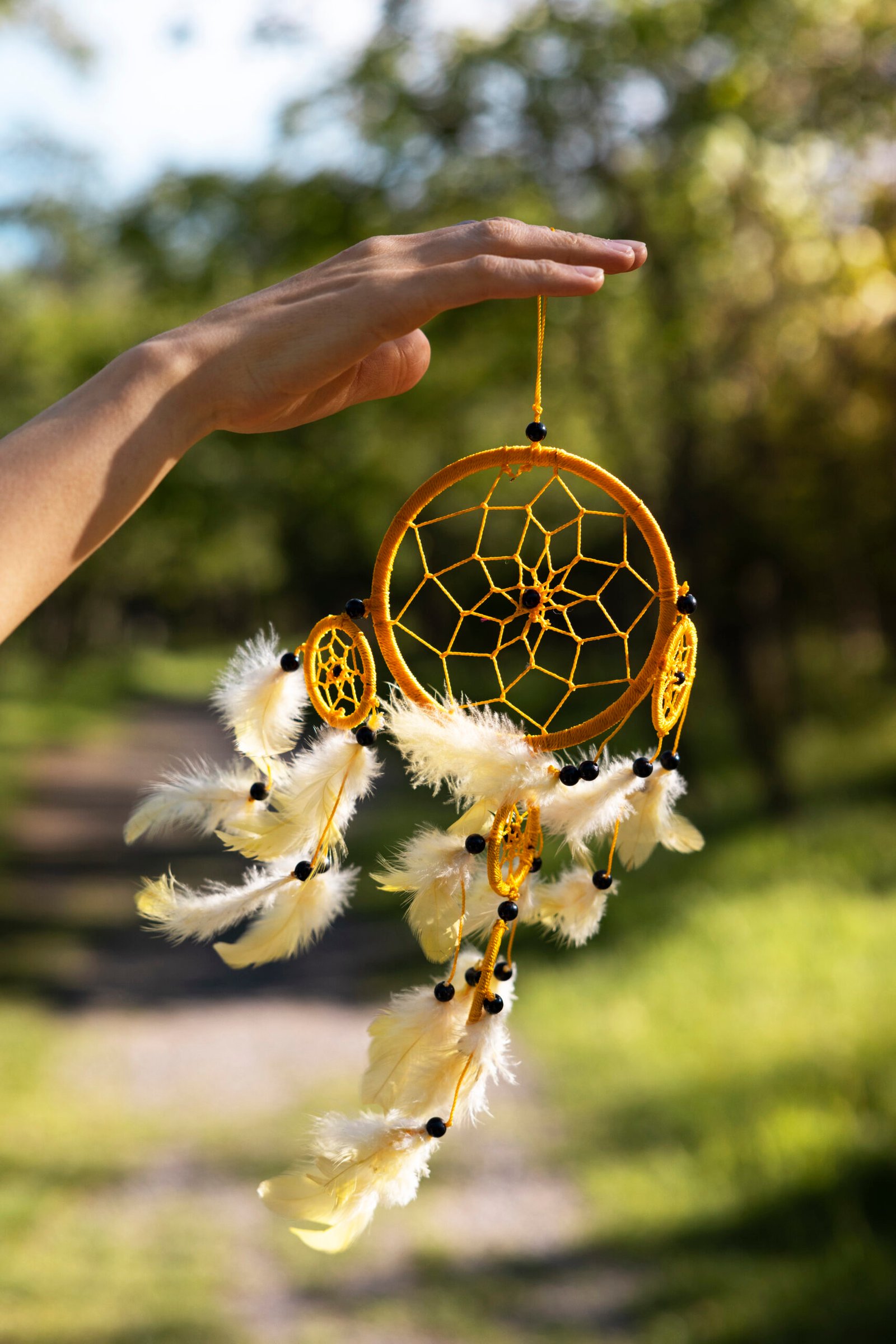 side-view-hand-holding-dream-catcher